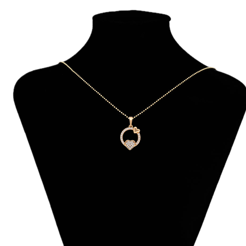 Gold necklace with a heart pendant on a black mannequin bust, branded 'Xupin'.
