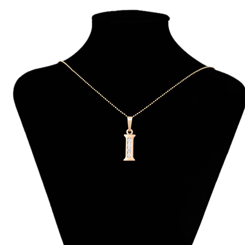 Gold necklace with a pendant on a black mannequin bust, branded 'Xupin'.