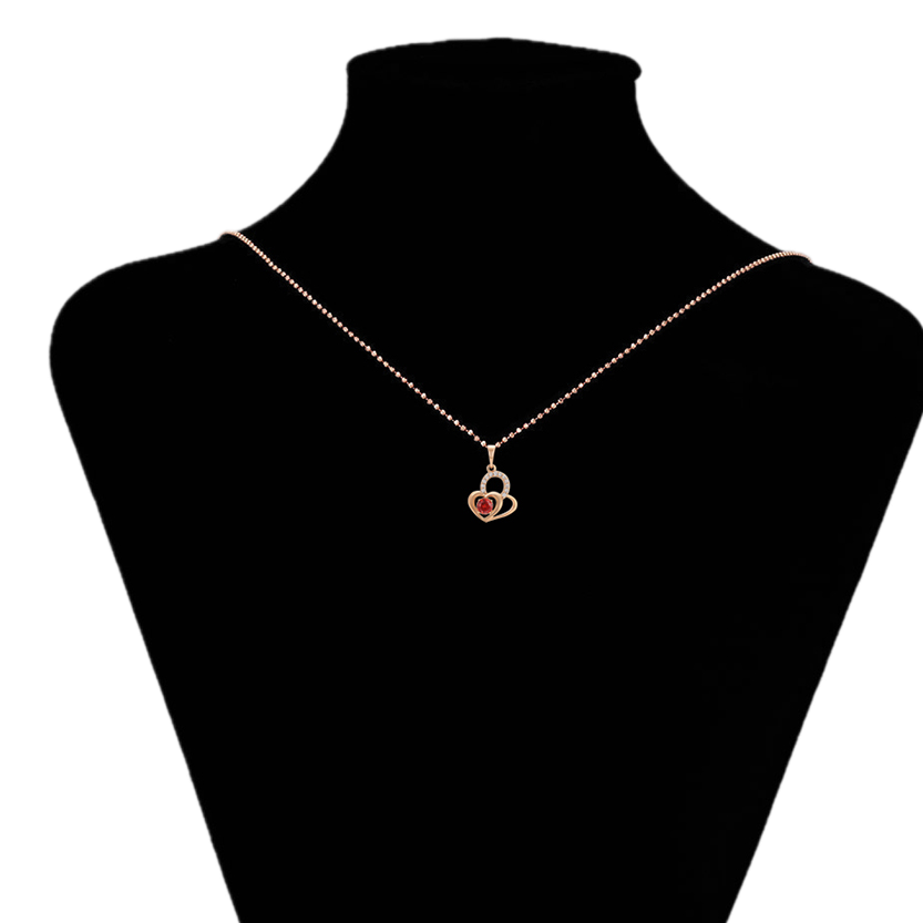 Necklace with a heart-shaped pendant on a black mannequin bust, brand 'Xupin' visible.