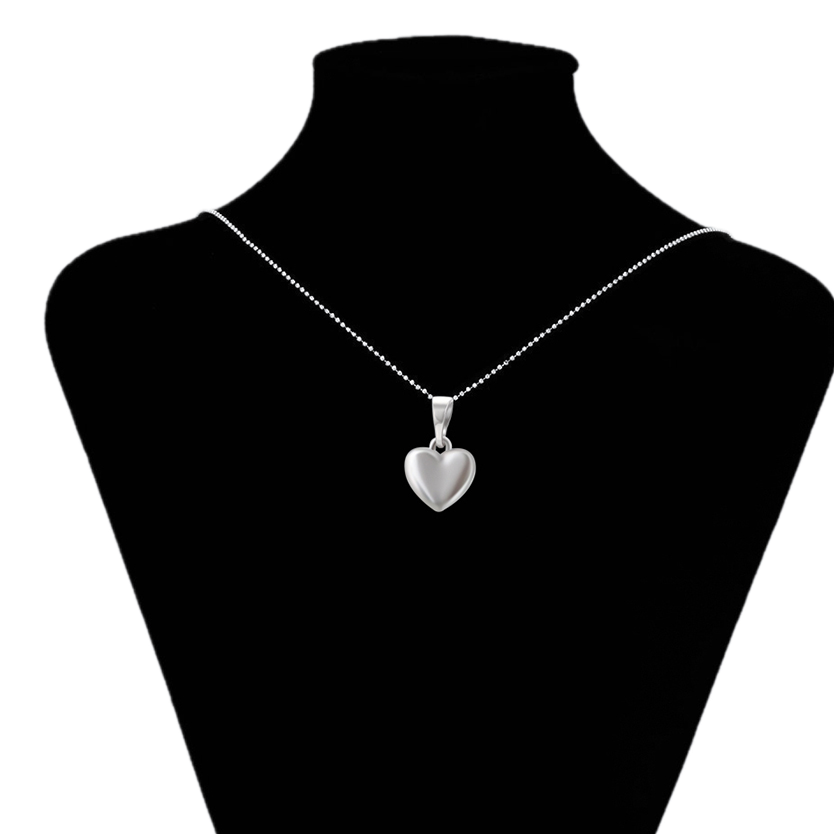 Silver heart-shaped pendant on a black mannequin with 'www.xupix.com' branding.