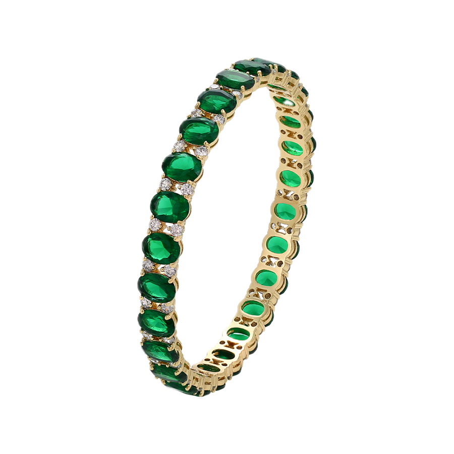Gold bracelet with green gemstones on a white background